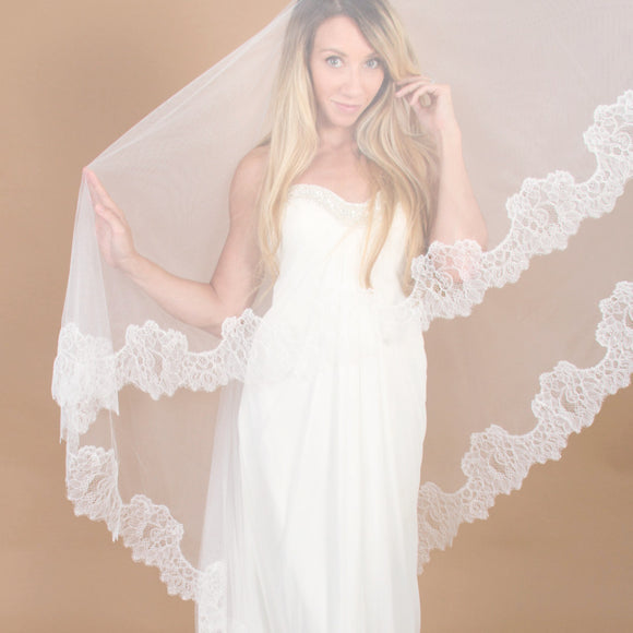https://www.themantillacompany.com/cdn/shop/products/Lace-cathedral-veil-mantilla-style-lucia-with-blusher-bride-posing_262d4503-0c36-4333-95fc-44dc58f44239.jpg?v=1559161884&width=580