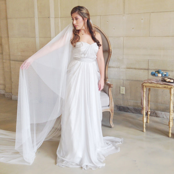 raw edge cathedral veil in ivory with blusher pulled back